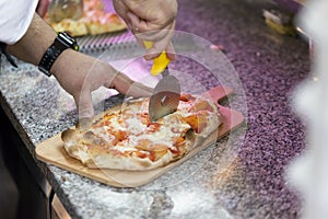 Chef cutting pizza