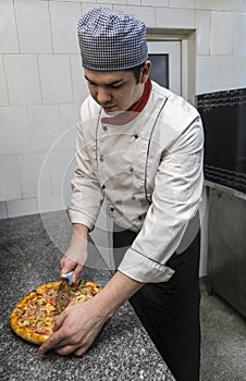 Chef Cutting the Pizza