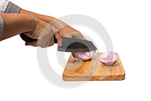 Chef cutting red onion with a knife on the cutting board isolate