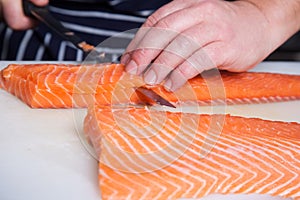 Chef cutting salmon fish