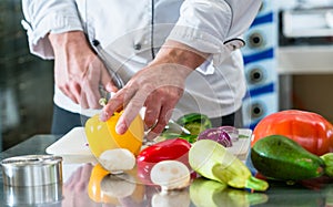 Chef cutting vegetables in his restaurant kitchen