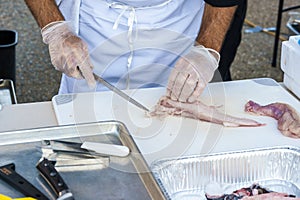 Chef deboning monkfish