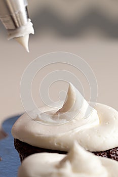 Chef decorating chocolate cupcakes