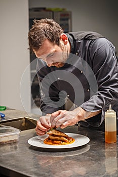 Chef is decorating delicious dish