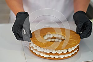 Chef decorating with a pastry bag with cream