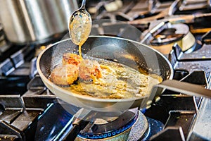 Chef decorating sweets at kitchen. Closeup male chef making dessert in motion. Professional cook decorating cake at workplace