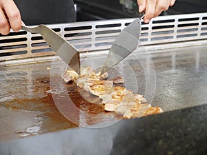 Chef Deliberately Preparing and Cooking Traditional Teppanyaki on Hot Plate