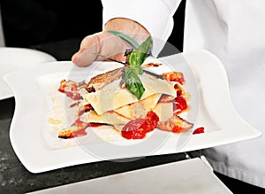 Chef demonstration preparing food photo