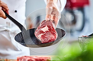 Chef displaying a raw thick rump steak