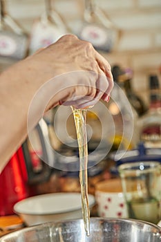 Chef drives an egg into bowl for cherry pie, clafoutis. Step by step recipe