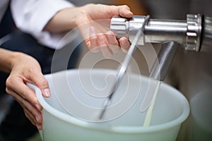 chef filling bucket with milk product