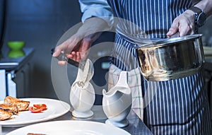 Chef finishing his plate and almost ready to serve