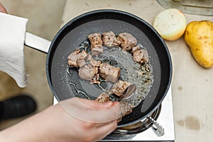 Chef Fried Marinated Diced Raw Beef in Pan with Rosemary Oil with Spoon