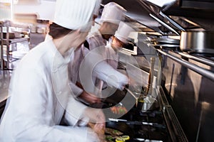 Chef frying fish in a frying pan