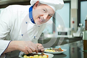 Chef garnishing a dish