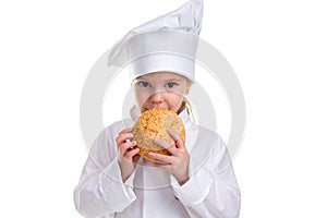 Chef girl in a cap cook uniform, holding and smelling the bread with sesame. Looking at the camera