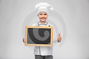 chef girl with chalkboard shows thumbs up