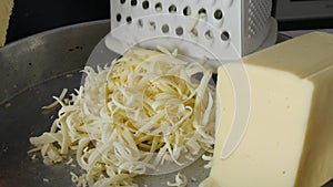 Chef grating cheese for pizza, close up