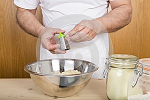 Chef gratting nutmeg on the gnocchi mix dough