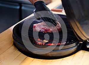 Chef grilling steak in a restaurant