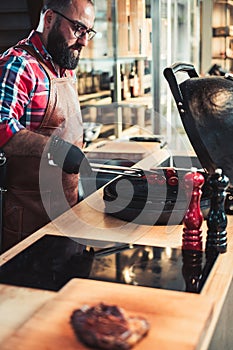 Chef grilling steak in a restaurant