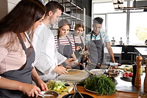 Chef and group of young people during cooking classes