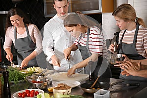 Chef and group of young people during cooking classes photo