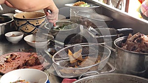 Chef hand making wonton noodles soup at restaurant \'s kitchen, mi hoanh thanh bowl