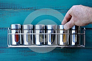 Chef hand returning spice into a spice rack