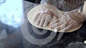 Chef hand use wood rolling thresh pizza flour Italian homemade pizzeria