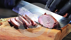 Chef hands chopping fresh juicy meat steak barbecue roasted slice use knife wooden board closeup