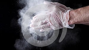 Chef Hands Clapping With Flour In Slow Motion on black background. Frame. Chef Claps Hands Together With Flour, Super