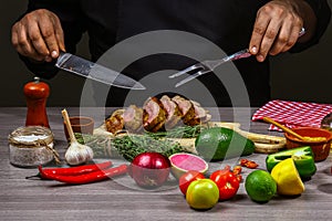 Chef hands Cooking meat steak, vegetables and spices with by chef hands on wooden background. Food recipe concept