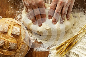 Chef hands with dough and homemade natural organic bread and flour