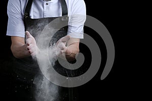 Chef hands in flour on black background. clap with flour. baking bread and and making pizza or pasta