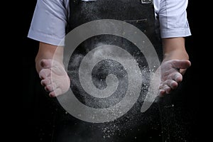 Chef hands in flour on black background. clap with flour. baking bread and and making pizza or pasta