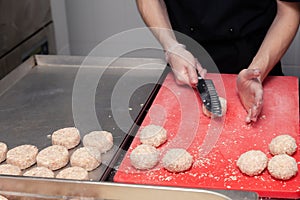 Chef hands in gloves creating forming chicken cutlets with knife for burgers. Ingredients. Concept restaurant business, fast food