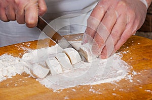 Chef hands in process of making home-made dumplings, ravioli