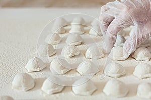 Chef hands putting handmade dumplings on table