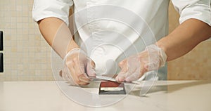 Chef hands sharpening knife in slow motion. Closeup man hands preparing professional tools for cooking food at kitchen