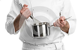 Chef hands with whisk and pan