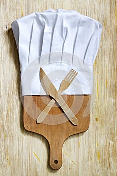 Chef hat and empty cutting board abstract food background