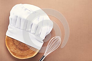 Chef hat on wooden cutting board