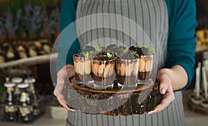 Chef holding chocolate dessert with blackberry