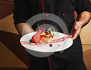 Chef holding contemporary restaurant dessert