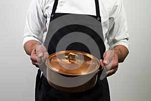 Chef holding copper pan