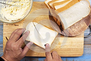 Chef holding knife cutting slide bread making on wooden  board