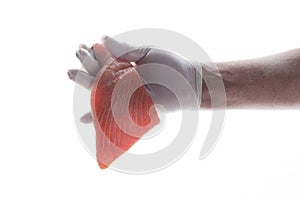 Cook is proposing fresh salmon for preparing a meal.Male hand in glove with tasty raw salmon