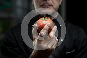 Chef holding a tomato