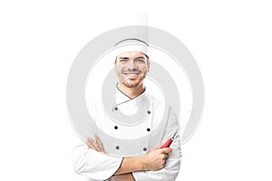 Chef holding a whisker and smiling